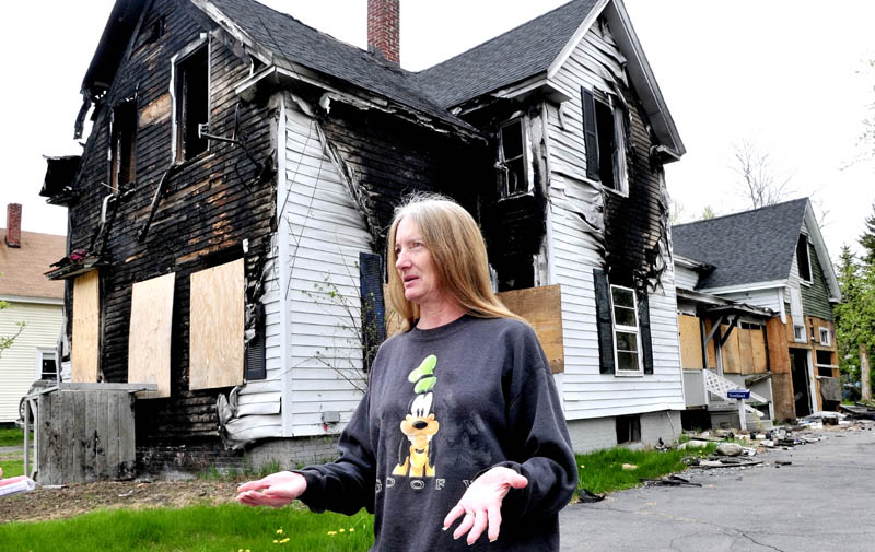 NEIGHBORHOOD CONCERN: Diana Foster speaks about her desire to have a neighbor's home demolished on Oak Street in Waterville. The home was destroyed and has been vacant since last year.