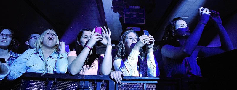 Front row fans snap pictures of country star Dierks Bentley as he performs Thursday night at the Augusta Civic.