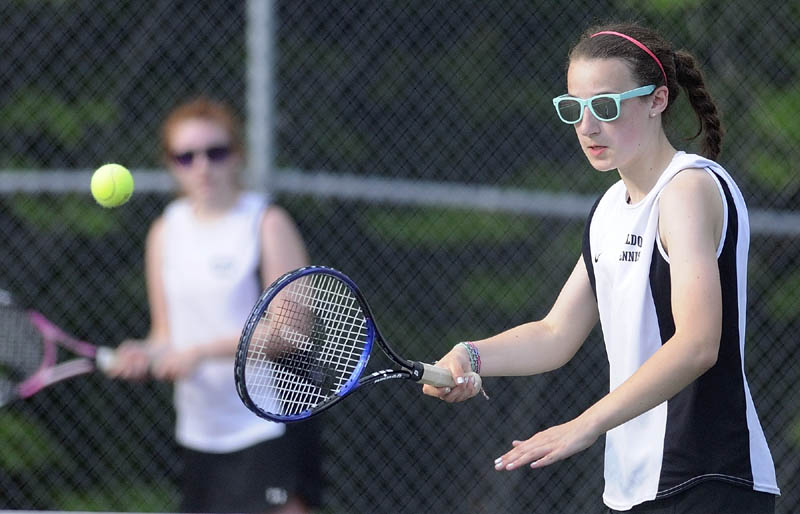 Hall-Dale’s Maura Stottler, right, returns a shot during a match as her second doubles teammate Anais Truman backs her up during the Mountain Valley Conference championship match on Wednesday at Hall-Dale High School in Farmingdale. Hall-Dale won 4-1.