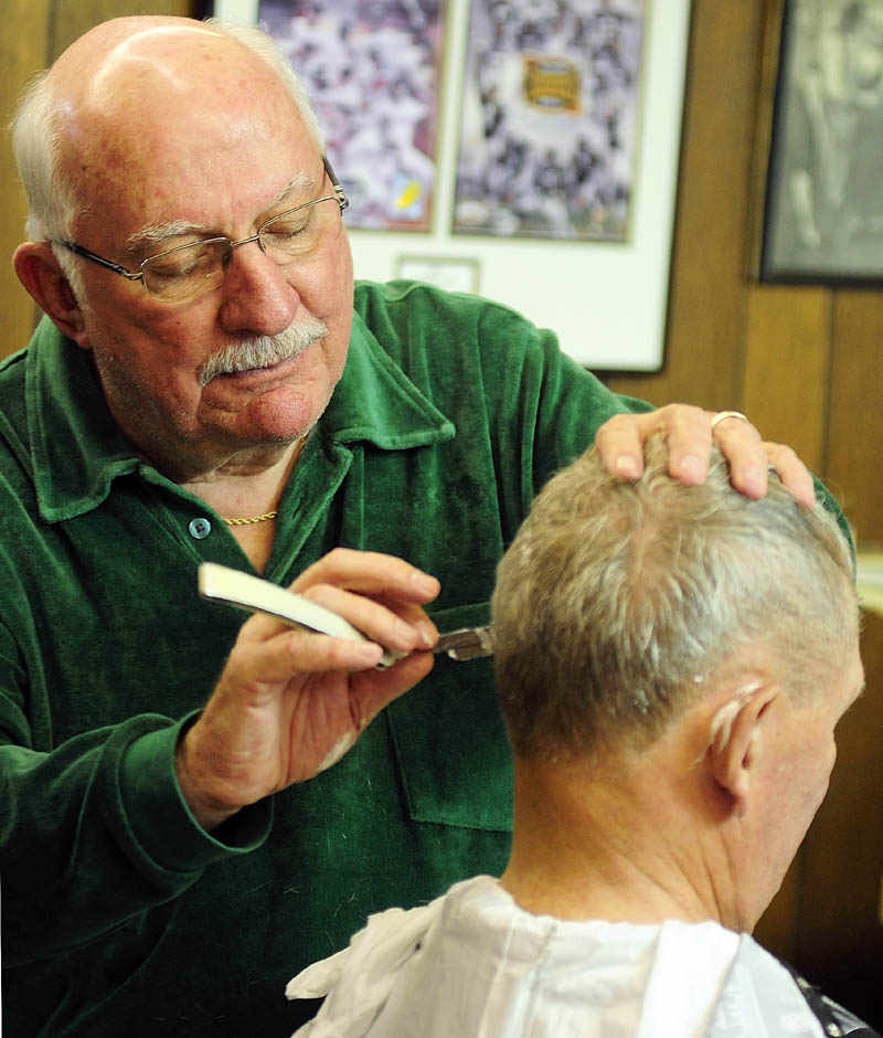 Francis Lorette shaves around Warrren Hayward's ears on Tuesday afternoon at Lorette's Barber Shop in Winthrop. Hayward didn't know that Lorrete had closed last Saturday. Since he'd stopped Lorrette gave a haircut and joked that Warren would be in trouble with is wife if he'd said he went out for a haircut but didn't one. Lorette closed his 49-year-old business last Saturday, but did two last haircuts on Tuesday afternoon before packing up his clippers.