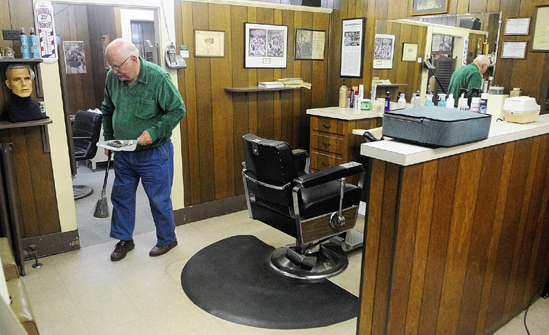 Francis Lorette sweeps up hair from the floor on Tuesday afternoon at Lorette's Barber Shop in Winthrop. Lorette closed his 49-year-old business on Saturday afternoon, but did two last haircuts on Tuesday afternoon before packing up his clippers.