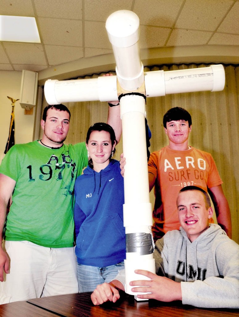 THE BEAST: Madison Area Memorial High School students hold their project called the "Floating Beast," a scale model offshore, floating, wind-turbine platform. From left are Travis Emerson, Jess Thebarge, Matt Soucy and Stephen Cusson, seated.
