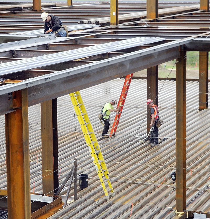 Construction workers are seen climbing among the girders during a recent tour of MaineGeneral's new regional hospital under construction in North Augusta.