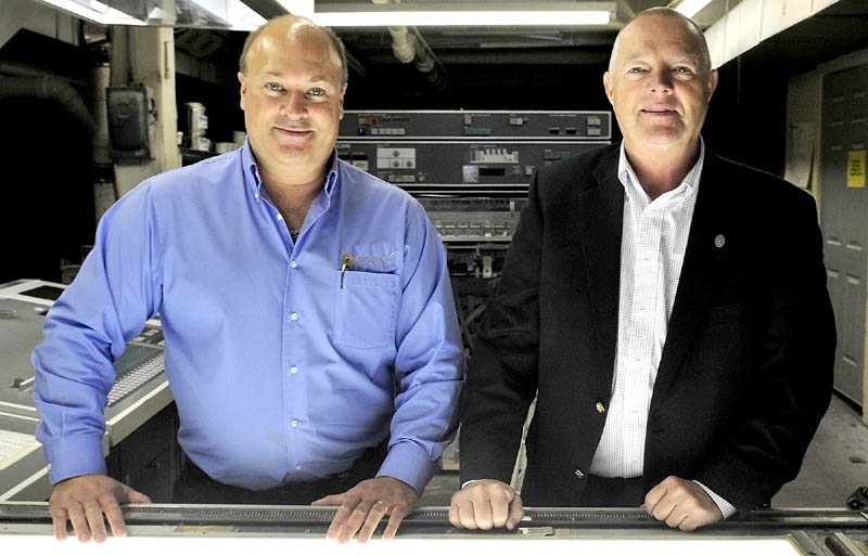 IN BUSINESS: Peter Schutte, left, and Mike Whitman inside the former Atkins Printing company in Waterville on Thursday. The men formed the Premier Color company, which will do business as Atkins Printing Services.