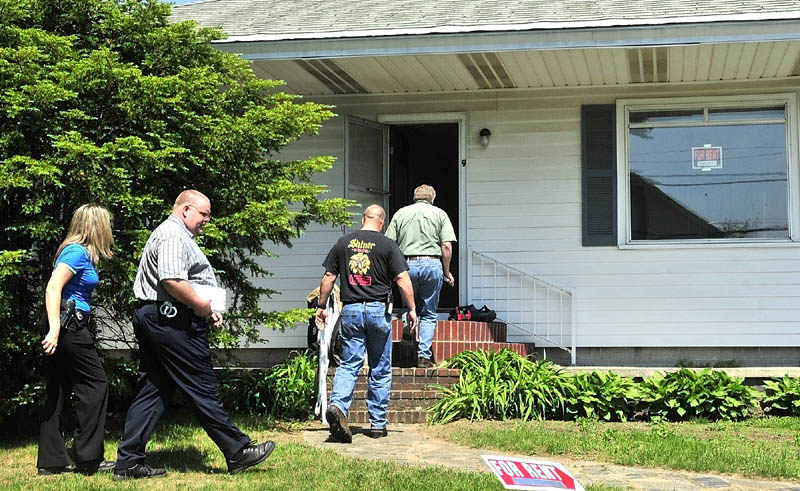 INVESTIGATORS: Stu Jacobs, right, of the state Fire Marshal's Office enters a home on Silver Street in Skowhegan on Monday to investigate the origin of a fire earlier in the day. Following Jacobs is Skowhegan firefighter Shaun Howard and Skowhegan Police Detectives Dan Summers and Kelley Hooper.