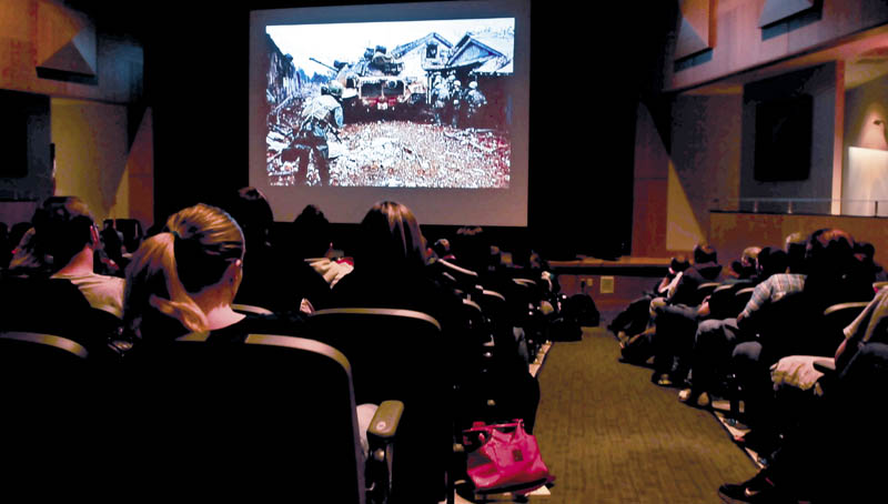 Mount View High School students watch a slide show presentation of images taken during the Vietnam War during a presentation by veteran Vince Gabriele at the Thorndike school on Wednesday.
