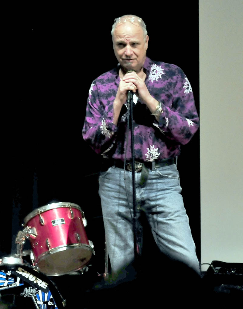 Staff photo by David Leaming MESSAGES: Vince Gabriel, Vietnam veteran, storyteller, and musician on Wednesday discusses his experinece during war time in a multimedia format to students at Mount View High School in Thorndike.