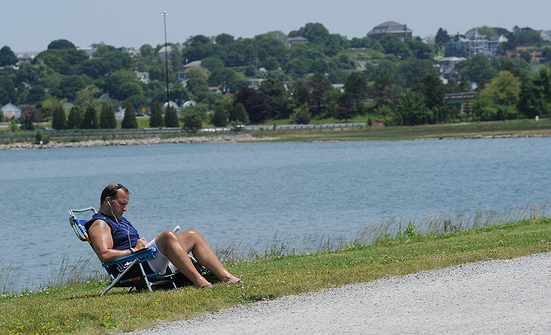 Scott Kauffman of Portland cools off at Back Cove in Portland today. He was editing a book he is writing.