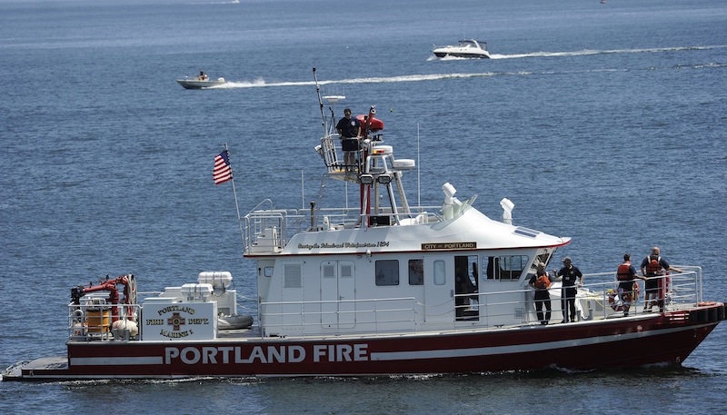 The Portland Fire Boat searches on the scene of a plane crash in Casco Bay near Fort Williams Sunday