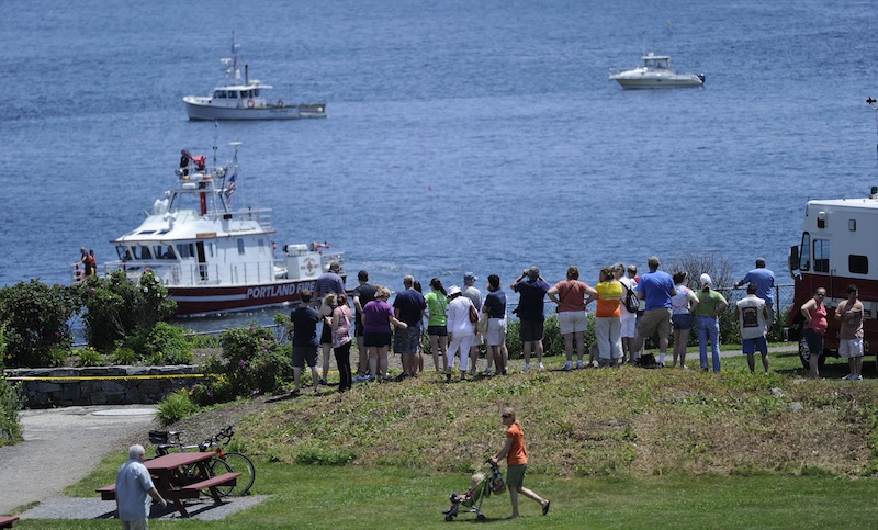 A crowd gathers at Fort Williams Park in Cape Elizabeth at the scene of a plane crash in Casco Bay on Sunday