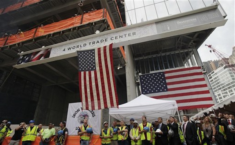 Construction workers and officials watch as the ceremonial last beam is hoisted to the top of Four World Trade Center, Monday, June 25, 2012. The 72-floor, 977-foot tower is scheduled to open late next year. It's expected to be the first tower completed on the 16-acre site since the 9/11 attacks. (AP Photo/Mark Lennihan) Silverstein;9/11;Sept 11;ground zero