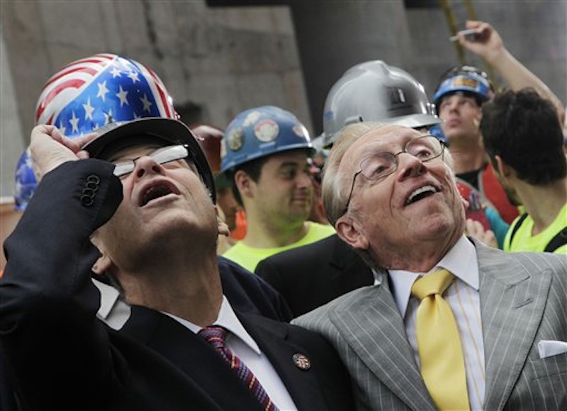 New York State Assembly Speaker Sheldon Silver, left, and developer Larry Silverstein watch as the ceremonial last beam is hoisted to the top of Four World Trade Center, Monday, June 25, 2012.. The 72-floor, 977-foot tower is scheduled to open late next year. It's expected to be the first tower completed on the 16-acre site since the 9/11 attacks. (AP Photo/Mark Lennihan) Silverstein;9/11;Sept 11;ground zero