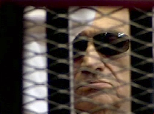 In this video image taken from Egyptian State Television, 84-year-old former Egyptian president Hosni Mubarak is seen in the defendant's cage as a judge reads the verdict on charges of complicity in the killing of protesters during last year's uprising that forced him from power.