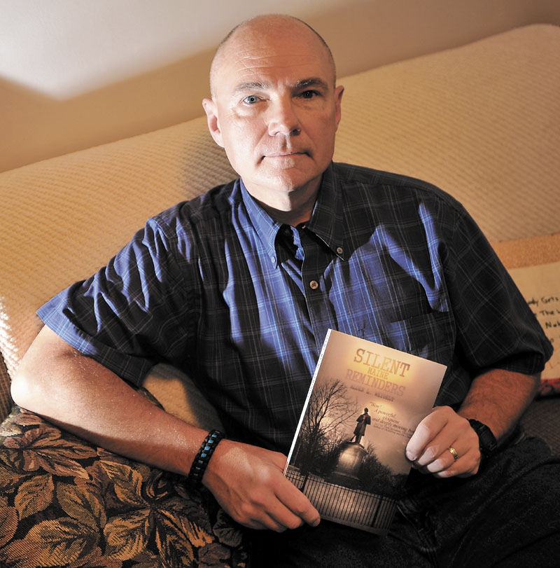 Waterville police officer Alden Weigelt holds a copy of his book "Silent Maine Reminders" at his home in Winslow on Thursday.