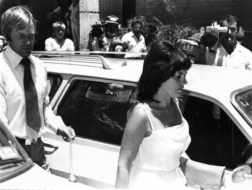 In this Feb. 2, 1982, photo, Michael, left, and Lindy Chamberlain leave a courthouse in Alice Springs, Australia. A coroner found today that a dingo took the Chamberlains' baby who vanished in the Australian Outback more than 32 years ago in a notorious case that split the nation over suspicions that the infant was murdered.