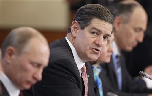 An October 2011 photo of James Turley, chairman and CEO of Ernst & Young, center, and Russian Prime Minister Vladimir Putin, left, attending a meeting of the Council on Foreign Investments in Moscow.