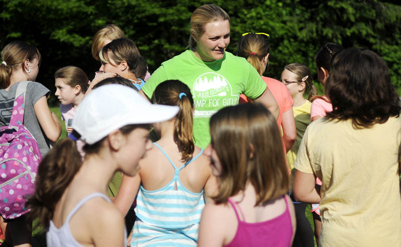 HAPPY CAMPERS: U.S. Olympic luger and Augusta native Julia Clukey, center, chats with campers Wednesday as they arrive for the first day of the Camp for Girls in Readfield. Operated in conjunction with Kennebec Valley YMCA, Julia Clukey's Camp for Girls welcomed 94 girls between the ages of 8-11 for a week of outside activities and development.