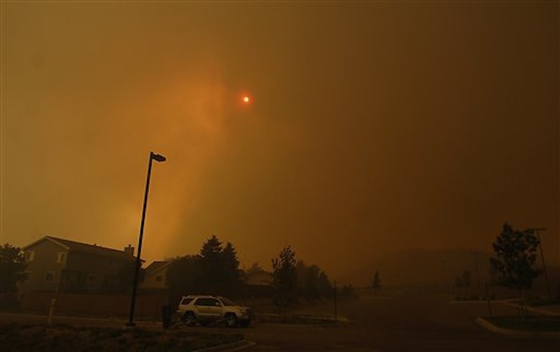 The skies are orange as flames from the Waldo Canyon Fire race through a neighborhood in west Colorado Springs, Colo. on Tuesday, June 26, 2012 leaving a trail of destruction, burning homes and buildings in its path. Heavily populated areas in the fire's path have been affected. (AP Photo/Bryan Oller) Bryan Oller;Waldo Canyon Fire;Colorado Springs Fire;forest fire