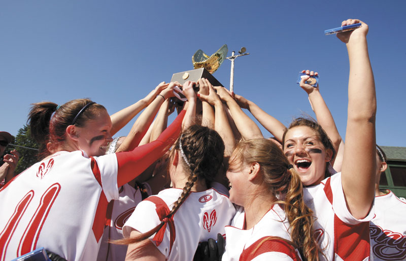 Gregory Rec/Staff Photographer: Cony players hoist the championship trophy and celebrate their perfect season with a win over South Portland in the Class A softball championship at St. Joseph's College in Standish on Saturday, June 16, 2012. Cony had a 22-0 season with their 2-0 win over the Red Riots on Saturday.