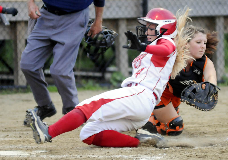 IN THERE SAFELY: Cony High School's Alyssa Brochu slides past the tag by Brewer High School's Sarah Babin at home plate during the Eastern Maine Class A softball championship game Tuesday in Augusta. Cony won 1-0.