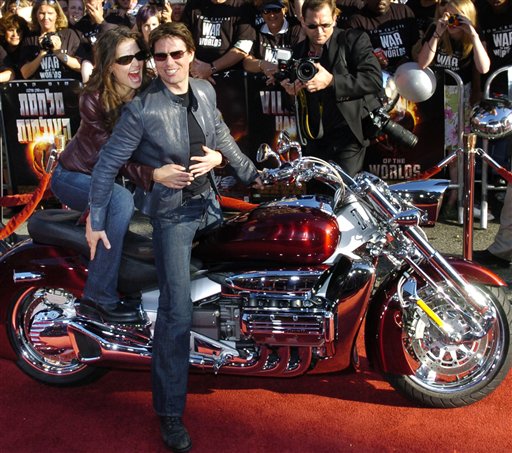 In this June 27, 2005, photo, Tom Cruise arrives with his then-fiancee Katie Holmes on a motorcycle for a screening of "War of the Worlds," in which Cruise starred.