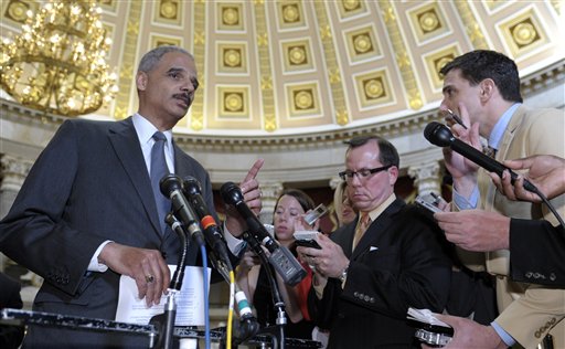 Attorney General Eric Holder speaks to reporters following a meeting on Capitol Hill on Tuesday. A House committee's chairman wants more Justice Department documents regarding Operation Fast and Furious, a flawed gun-smuggling probe in Arizona. The House committee voted Wednesday to hold Holder in contempt for failing to turn over the documents.