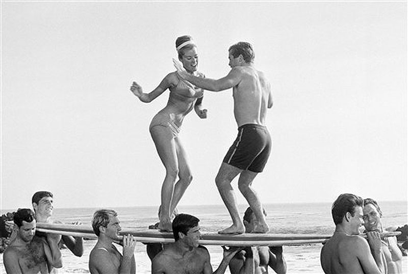 In this January 5, 1965, file photo, actors in a Hollywood movie dance "the twist" in Malibu, Calif. The Federal Reserve announced Wednesday, June 20, 2012, it is extending its "Operation Twist" program, which is named after the dance craze in an a nod to economic history when the Kennedy administration cut long-term rates while leavings short-term rates alone in the early 1960s. The program is designed to spur borrowing and spending. (AP Photo/File) "1960s lifestyle";"beach movie";bathing;suits;Beach;Dance;Entert