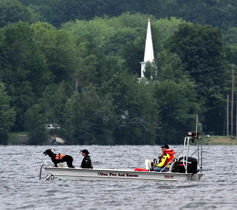 CHINA LAKE: Searchers with the Maine Warden Service scan an area of China Lake for missing swimmer Tye Feihel, 43, on Tuesday. Feihel was reported missing when he didn’t return from his usual afternoon swim.