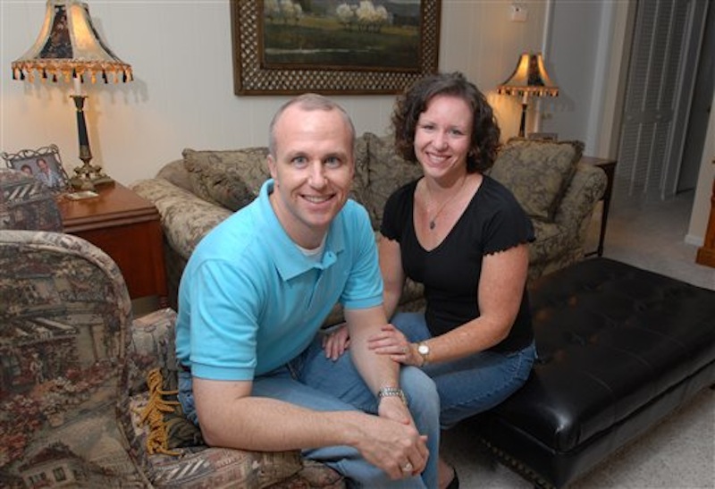 In this Thursday, May 11, 2006 file photo, Alan Chambers, left, president of Exodus International, sits with his wife, Leslie, in their home in Winter Park, Fla. The president of the country's best-known Christian ministry dedicated to helping people repress same-sex attraction through prayer is trying to distance the group from the idea that gay people's sexual orientation can be permanently changed or "cured." Chambers said Tuesday, June 26, 2012 that their upcoming national conference would highlight his efforts to dissociate the group from the controversial practice usually called ex-gay, reparative or conversion therapy. (AP Photo/Phelan M. Ebenhack)
