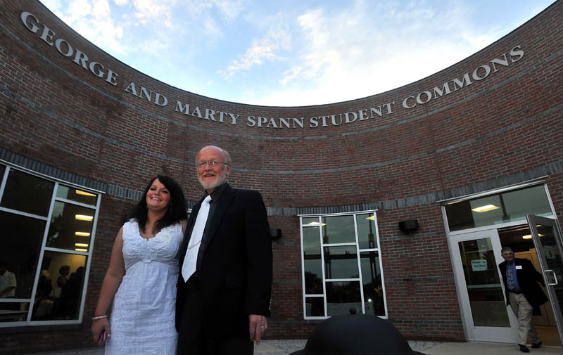 George Spann and his daughter Jennifer pose for pictures in the court yard of the new student center after a presentation honoring the retiring college president Friday in Waterville. Thomas College honored George Spann, president of the college since 1989, and his late wife Marty, who died last year, by naming the new student center after the couple.