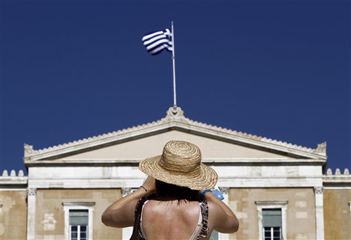 A tourist takes photos of the Parliament in Syntagma square in central Athens on Thursday. A Greek election on Sunday will go a long way toward determining whether Greece drops the euro as its currency.