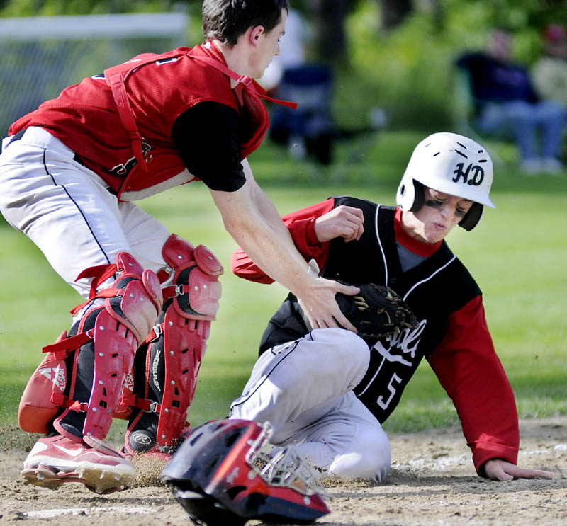 TAGGED OUT: Hall-Dale’s Bobby Cumler gets tagged out at home by Wiscasset’s Devin Grover during the Bulldogs’ 7-2 win in a Western C regional quarterfinal game Wednesday in Farmingdale.