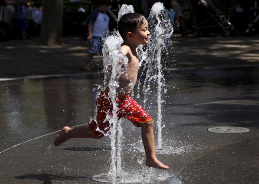 Nicholas McGrath, 3, of Arizona plays in a fountain in New York today. The National Weather Service has forecast potentially record-breaking temperatures for today, which is the summer solstice and longest day of the year.