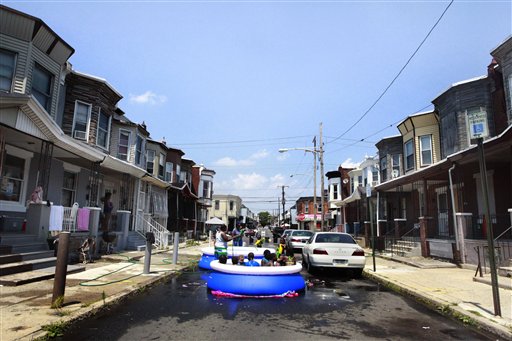 Residents of a Philadelphia neighborhood set up a pool in the street to swim and stay cool on Wednesday. The mercury in Philadelphia rose to 97 degrees, one degree short of the record of 98 set in 1931.