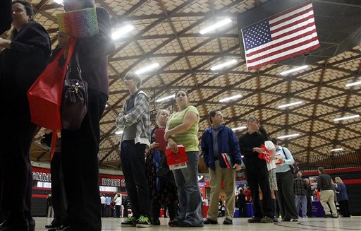 People wait in a line recently at a job fair in Gresham, Ore. The Labor Department says job openings fell to a seasonally adjusted 3.4 million in April, down from 3.7 million in March.