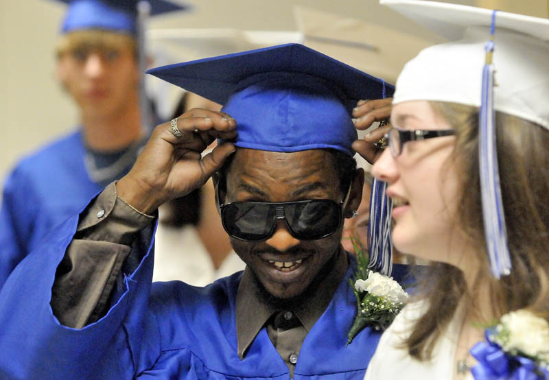 Lawrence High School Adult Education graduate Bert Brown prepares for graduation ceremonies at Lawrence High School in Fairfield on Wednesday night.