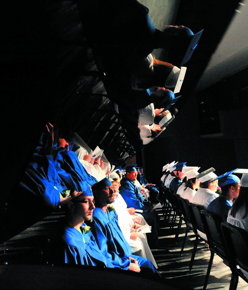 Staff Photo by Michael G. Seamans Lawrence High School Adult Education graduates sit on the stage at the performing arts center during graduation ceremonies at Lawrence High School in Fairfield Wednesday night.