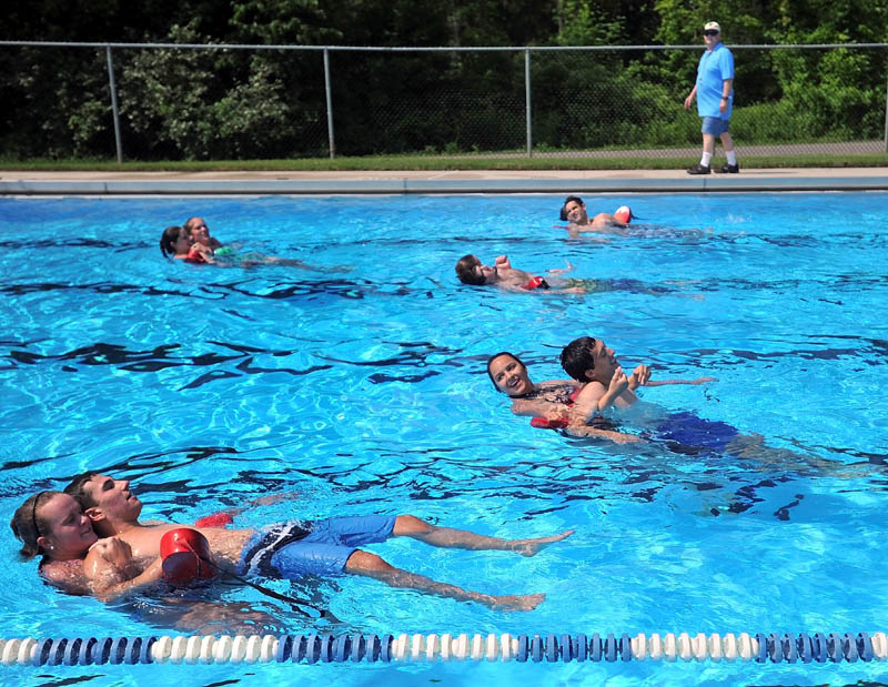 TRAINING: David Turnage walks along the edge of the pool as lifeguards train for the summer season on Thursday at the Waterville Parks and Recreation swimming pool on North Street.