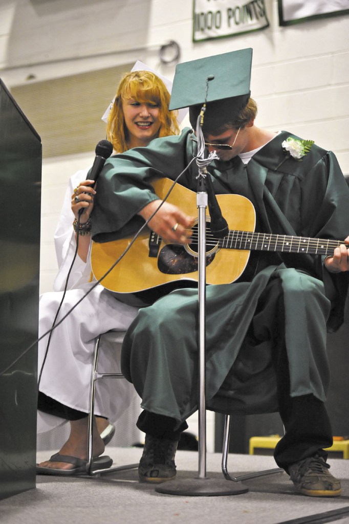 DUET: Graduates Alaena Merrill of Solon and Zach Browne of North Anson sing a duet together during a break in the ceremony.