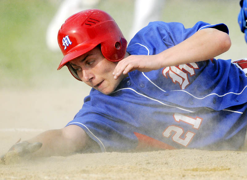 COMING HOME AGAIN: Messalonskee High School’s Reid Nutter slides safely into home plate during the Eagles’ 13-2 win over Lewiston in the Eastern Maine Class A championship game Tuesday at Morton Field in Augusta.