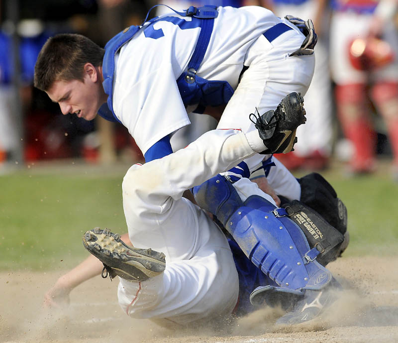 CLOSE PLAY: Messalonskee High School’s Travis St. Pierre is tagged at home plate by Lewiston High School’s Shawn Ricker during the Eagles’ 13-2 win in the Eastern Maine Class A championship game Tuesday in Augusta.