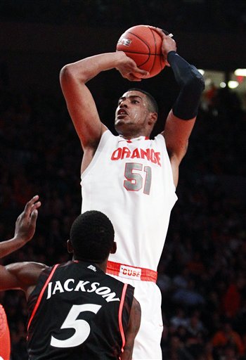 FILE - This March 9, 2012 file photo shows Syracuse's Fab Melo (51), of Brazil, shooting over Cincinnati's Justin Jackson (5) during the first half of an NCAA college basketball game in the semifinals of the Big East Conference tournament in New York. Melo is a possible pick in the NBA Draft on June 28. (AP Photo/Frank Franklin II, File)