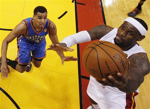 Miami Heat small forward LeBron James (6) shoots as Oklahoma City Thunder shooting guard Thabo Sefolosha (2) of Switzerland defends during the second half at Game 4 of the NBA finals basketball series, Tuesday, June 19, 2012, in Miami. The Heat won 104-98. (AP Photo/Mike Segar, Pool)