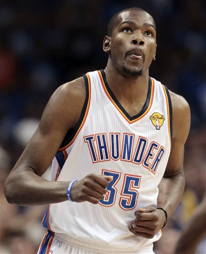 Oklahoma City Thunder small forward Kevin Durant (35) looks at the scoreboard against the Miami Heat during the first half at Game 1 of the NBA finals basketball series, Tuesday, June 12, 2012, in Oklahoma City. (AP Photo/Jeff Roberson)