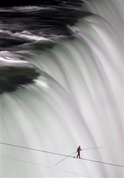 Nik Wallenda walks over Niagara Falls on a tightrope in Niagara Falls, Ontario, on Friday, June 15, 2012. Wallenda has finished his attempt to become the first person to walk on a tightrope 1,800 feet across the mist-fogged brink of roaring Niagara Falls. The seventh-generation member of the famed Flying Wallendas had long dreamed of pulling off the stunt, never before attempted. (AP Photo/The Canadian Press, Frank Gunn) general;art;artistic;arts;Canada;Canadian;Ent;entertain;entertainer;entertainers;entertaining;entertainment;performance;performing;expression;image;photograph;photographed;picture;portraits;pose;poses;posing;profile;portrait;Falls;Tight;Tight rope;Walk;Danger;Water;Waterfalls;United States;USA;Wire;Conditions;Wet;River;Hight;Fall;Slip;Mist;Lights;Distance;Feet;Meters;Audience;High;Balance;Pole;Beam;Victory;Accomplish;balance beam;acrobat;acrobatics;apparaus;athlete;athletes;athletic;athletics;competative;compete;competing;competition;competitions;event;exercise;gym;parallel;rhythm;routine;skill;skills;sport;sporting;sports;gymnastics