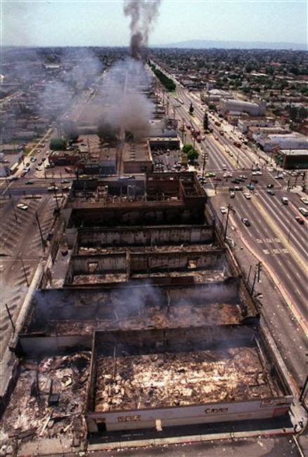 This April 30, 1992 file photo shows smoke rising as fires like this one near Vermont Street burn out of control in Los Angeles. Rodney King, the black motorist whose 1991 videotaped beating by Los Angeles police officers was the touchstone for one of the most destructive race riots in the nation's history, has died, his publicist said Sunday, June 17, 2012. He was 47. (AP Photo/Paul Sakuma, file)