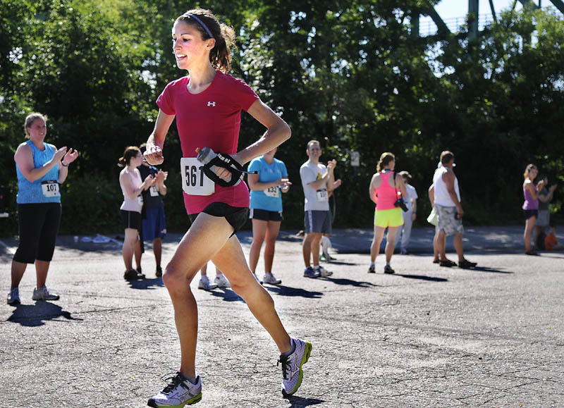 HEADING HOME: Michelle Weissman runs to the finish line of the Kennebec River Rail Trail Half Marathon on Sunday in Augusta. Weissman was the first female finisher.
