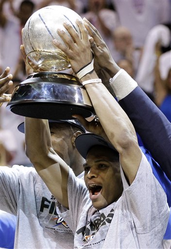 Oklahoma City Thunder point guard Russell Westbrook holds the western conference trophy after Game 6 in the NBA basketball Western Conference finals against the San Antonio Spurs, Wednesday, June 6, 2012, in Oklahoma City. The Thunder won 107-99 and move on to the NBA Finals. (AP Photo/Eric Gay)