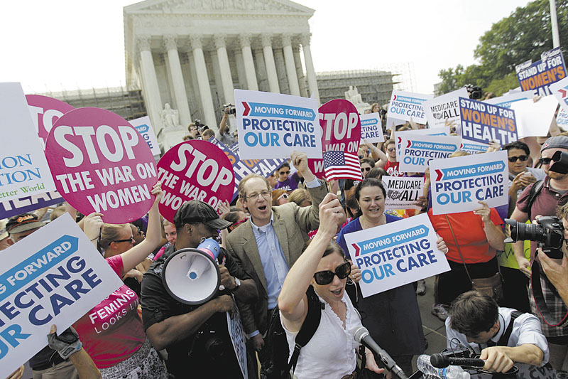 Supporters of President Barack Obama's health care law celebrate Thursday outside the Supreme Court in Washington after the court's ruling.