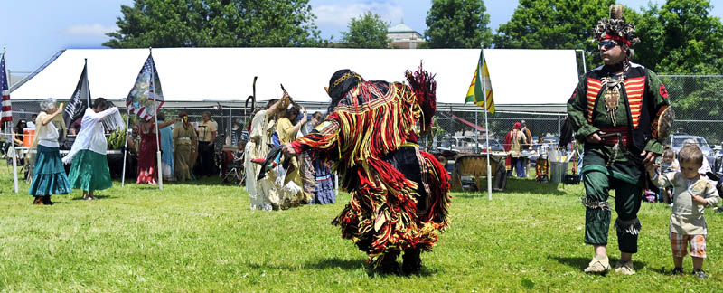 People clad in American Indian regalia dance together Sunday during the Honoring Our Veterans Powwow at Togus.